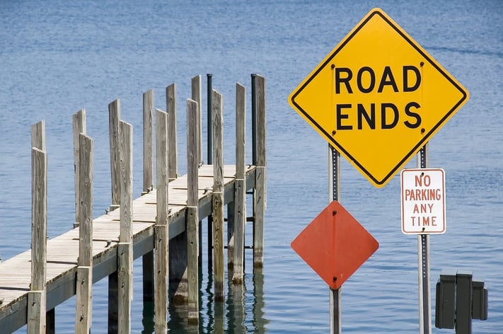 Pier and yellow ROAD ENDS sign by water.jpeg